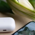 Literacy Technology - A white phone with a flower on it next to a book