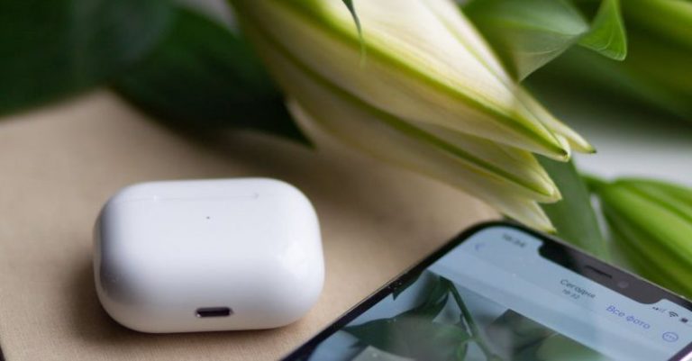 Literacy Technology - A white phone with a flower on it next to a book