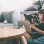 Mobile Learning - Woman Sitting on Bean Bag White Using Macbook in Front of Round Table With Green Leafed Plant