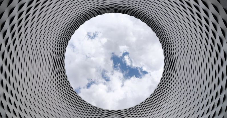 Future Cities - Low-angle Photography of Grey and Black Tunnel Overlooking White Cloudy and Blue Sky