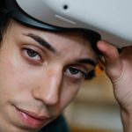 Cybersecurity Future - Young male gamer wearing VR headset for exploring cyberspace and playing video games looking at camera