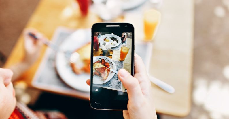 Food Technology - Person Holding Phone Taking Picture of Served Food