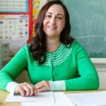 Education Future - Woman in Green Long Sleeve Shirt Writing on Paper