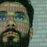 Coding Green - Man With Binary Code Projected on His Face