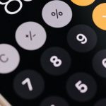 Divide Digital - Smartphone with calculator app showing total amount