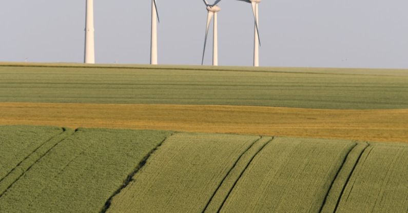 Telecommuting Eco - Wind Turbines on Horizon in Countryside