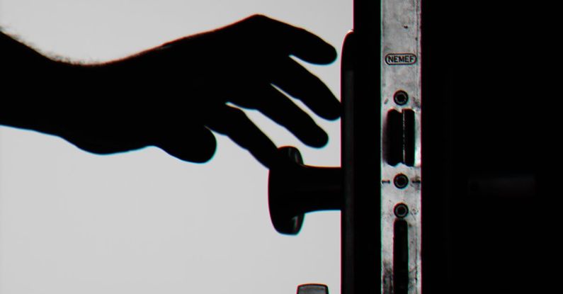 Biometric Security - Silhouette Photo of Person Holding Door Knob