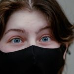 Ransomware Protection - A woman wearing a black mask with blue eyes