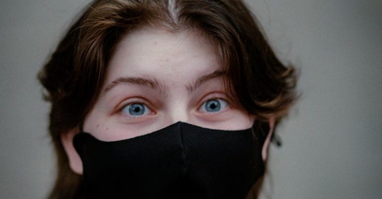 Ransomware Protection - A woman wearing a black mask with blue eyes