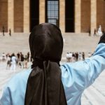 Microcredentials Education - A woman in a hijab holding a graduation cap