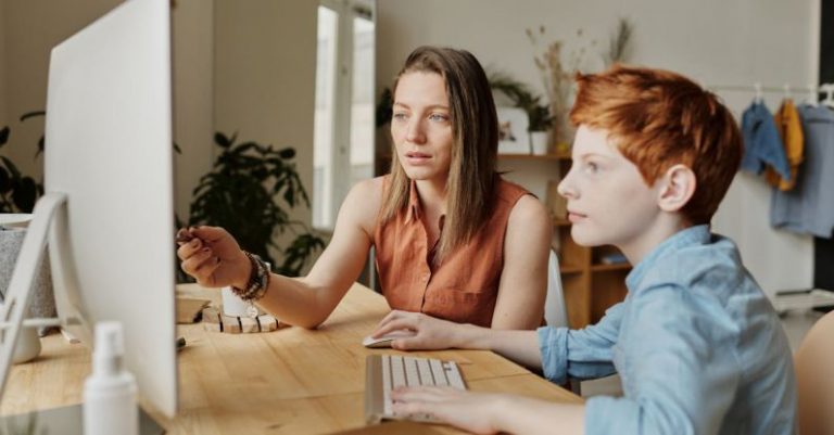 Smart Classroom - Photo Of Woman Tutoring Young Boy