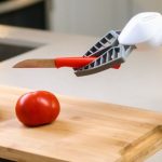 AI Surveillance - A Clicbot Slicing Holding a Knife Near Wooden Chopping Board